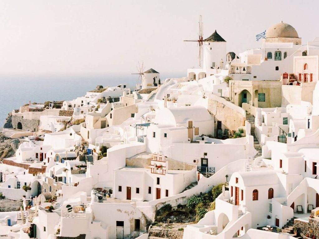 The sugar cube white buildings of Santorini and set against the sea - a romantic destination for a honeymoon in Europe