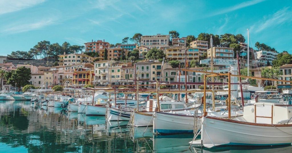 The beautiful town of Soller in Mallorca showing the boats moored and pretty buildings on the hillside