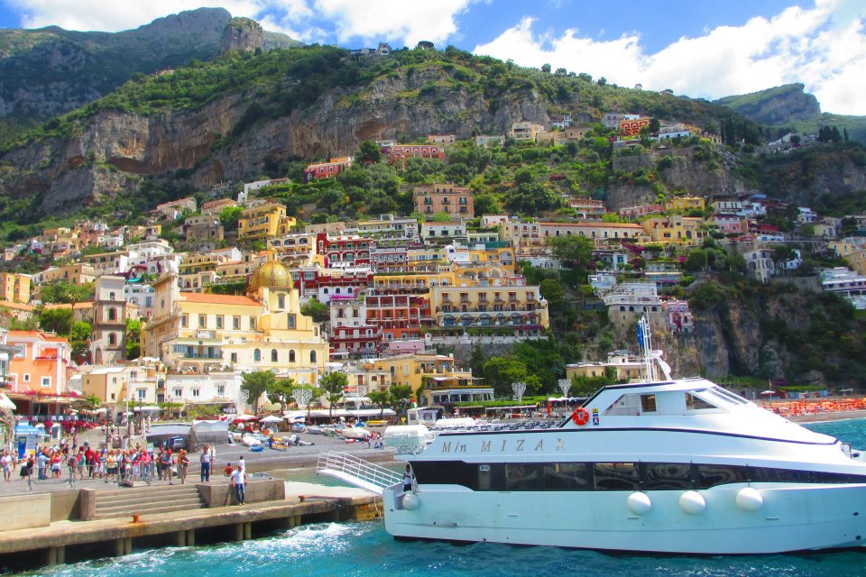 The bright colourful buildings of the Amalfi Coast taken from the sea - an iconic honeymoon destination in Europe