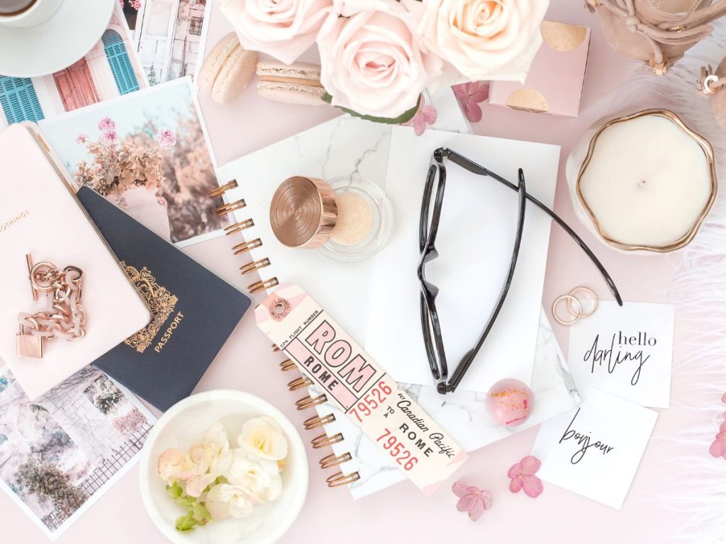 Notebook passport postcards and sunglasses flatlay